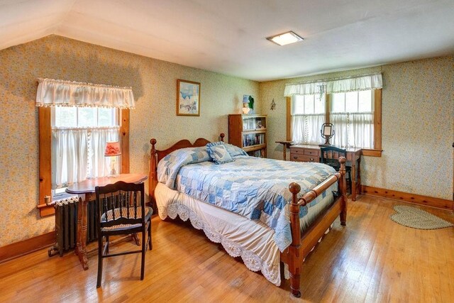 1031 Main St, Middletown, NY 12455 - bedroom with wallpapered walls, light wood-type flooring, and lofted ceiling