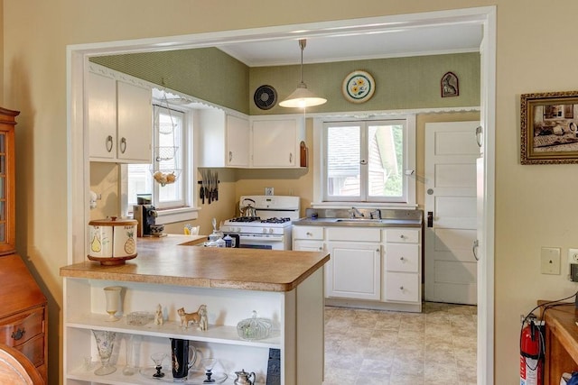 1031 Main St, Middletown, NY 12455 - kitchen featuring white range with gas cooktop, open shelves, a sink, white cabinets, and plenty of natural light
