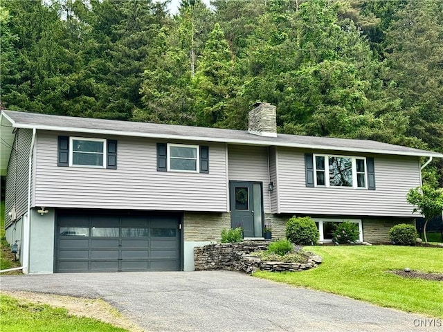 8521 Cazenovia Rd, Pompey, NY 13104 - split foyer home featuring a garage, driveway, a front lawn, a chimney, and a forest view