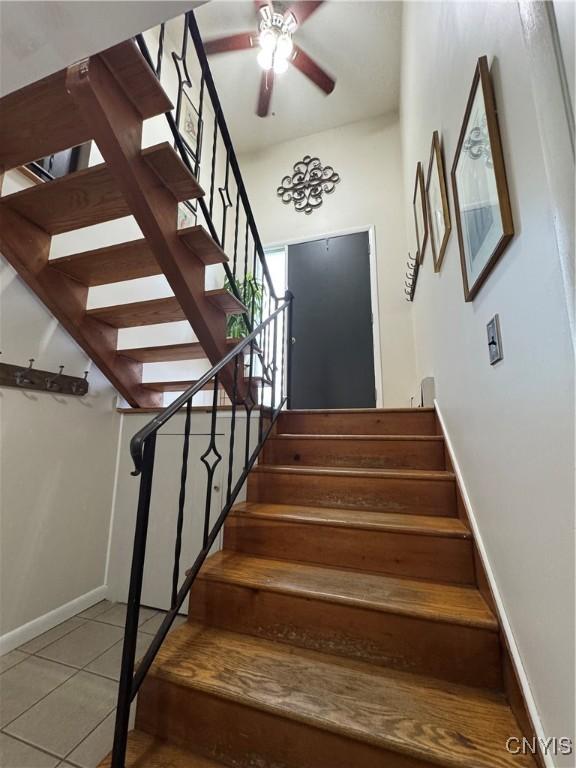 8521 Cazenovia Rd, Pompey, NY 13104 - stairway with ceiling fan, tile patterned flooring, and baseboards