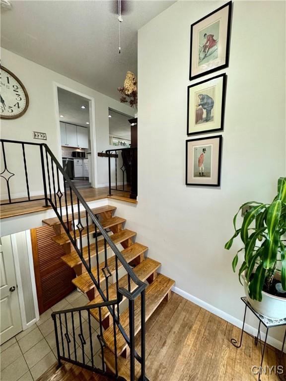 8521 Cazenovia Rd, Pompey, NY 13104 - stairway with baseboards and wood finished floors