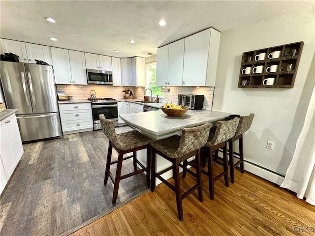 8521 Cazenovia Rd, Pompey, NY 13104 - kitchen with stainless steel appliances, a sink, dark wood-type flooring, white cabinets, and recessed lighting