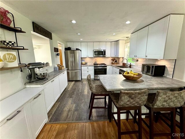 8521 Cazenovia Rd, Pompey, NY 13104 - kitchen with stainless steel appliances, a sink, open shelves, white cabinets, and recessed lighting