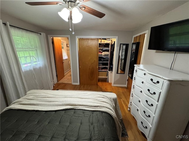 8521 Cazenovia Rd, Pompey, NY 13104 - bedroom with a spacious closet, light wood-style floors, a closet, ceiling fan, and baseboard heating