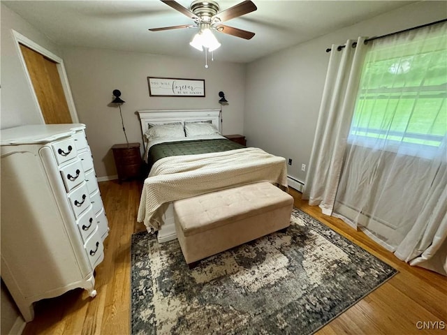 8521 Cazenovia Rd, Pompey, NY 13104 - bedroom featuring a baseboard radiator, light wood-type flooring, and a ceiling fan