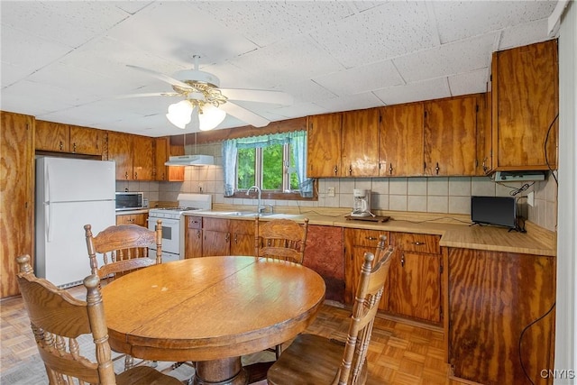338 Dutch Hill Rd Unit 326, Parish, NY 13167 - kitchen featuring white appliances, a sink, under cabinet range hood, brown cabinets, and ceiling fan