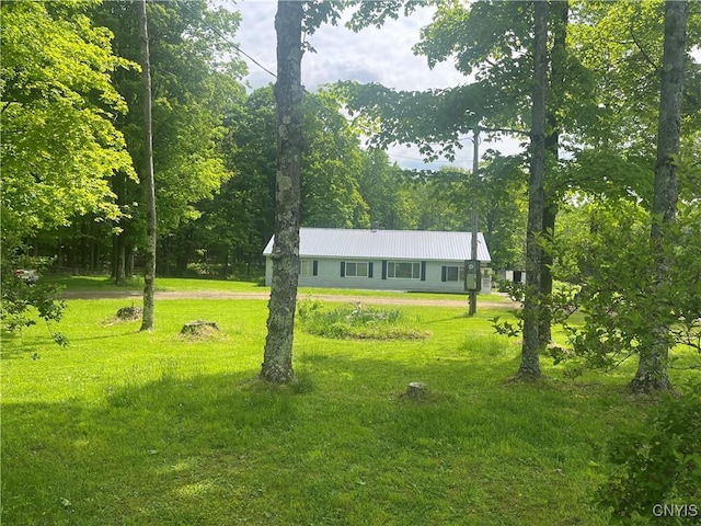 338 Dutch Hill Rd Unit 326, Parish, NY 13167 - view of front facade featuring a front lawn, metal roof, and a wooded view