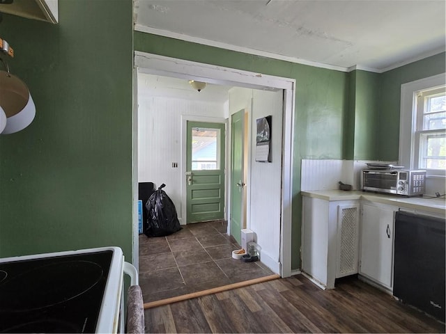 78 W Main St, Sidney, NY 13838 - kitchen featuring stove, ornamental molding, white cabinets, light countertops, and dark wood-style floors