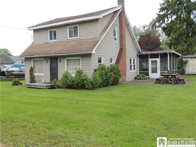 3931 S Ralph Ave, Ellery, NY 14712 - rear view of property featuring a sunroom, a lawn, and a shingled roof