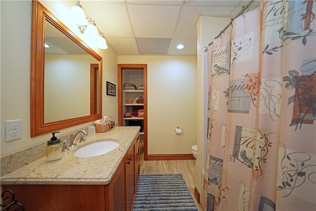 9867 State Route 961f Rd, Burns, NY 14807 - bathroom featuring wood finished floors, a drop ceiling, vanity, toilet, and baseboards