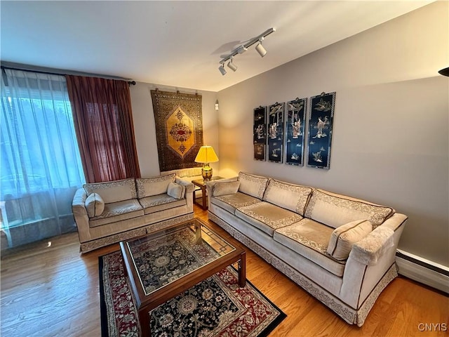 107 Rosewell Mdw, Dewitt, NY 13214 - living area with wood finished floors, baseboard heating, and track lighting