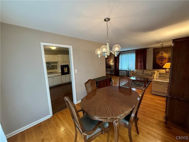 107 Rosewell Mdw, Dewitt, NY 13214 - dining room featuring light wood-style flooring, a chandelier, and baseboards