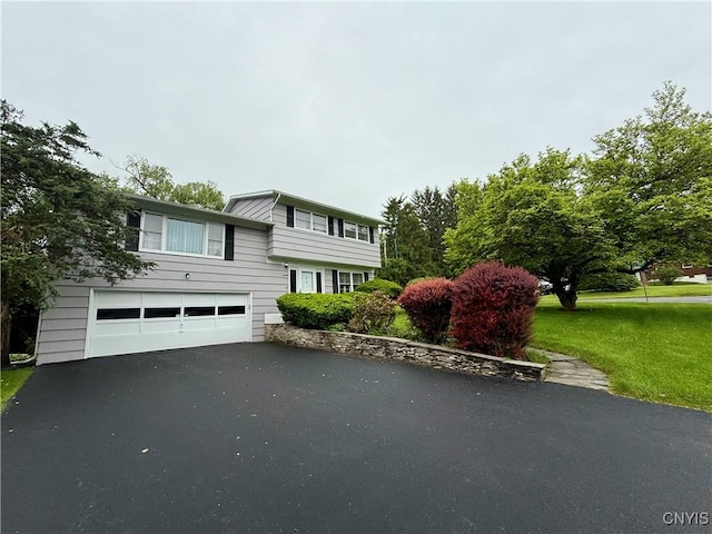 107 Rosewell Mdw, Dewitt, NY 13214 - view of front facade featuring a garage, asphalt driveway, and a front yard