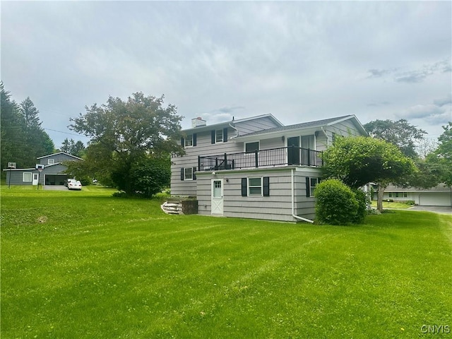 107 Rosewell Mdw, Dewitt, NY 13214 - back of house featuring a balcony, a lawn, and a chimney