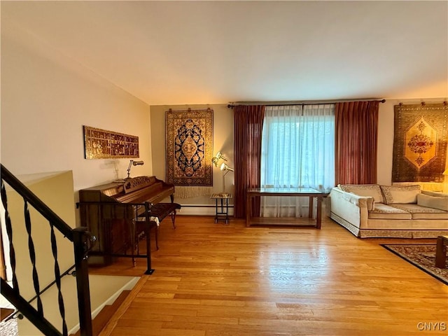 107 Rosewell Mdw, Dewitt, NY 13214 - living room with wood finished floors, a baseboard radiator, and stairway