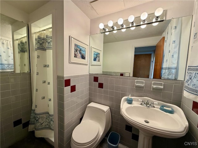 107 Rosewell Mdw, Dewitt, NY 13214 - bathroom featuring tile walls, wainscoting, toilet, and a sink
