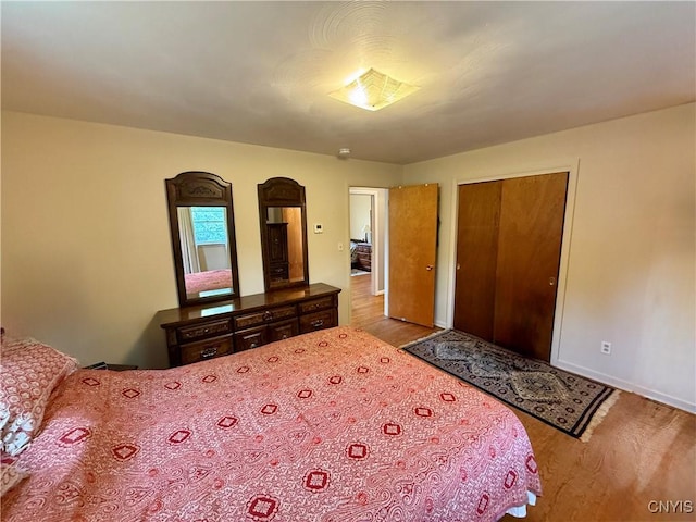 107 Rosewell Mdw, Dewitt, NY 13214 - bedroom featuring wood finished floors, a closet, and baseboards
