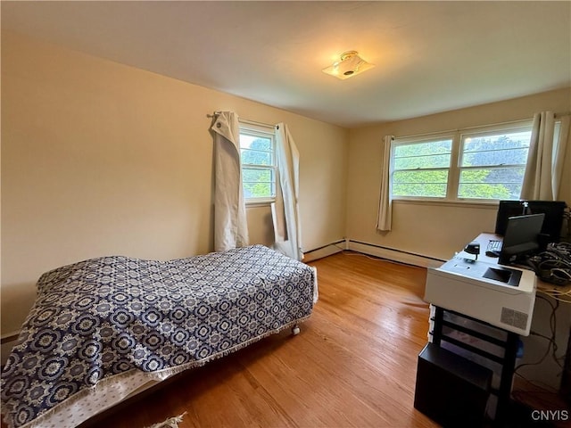 107 Rosewell Mdw, Dewitt, NY 13214 - bedroom featuring wood finished floors and a baseboard heating unit