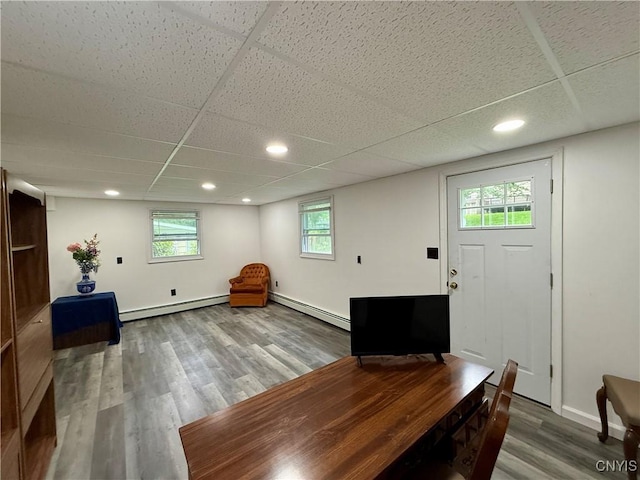 107 Rosewell Mdw, Dewitt, NY 13214 - entryway featuring a baseboard heating unit, wood finished floors, a paneled ceiling, baseboards, and plenty of natural light