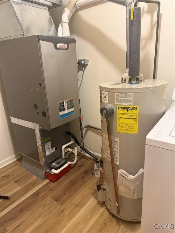 232 Millen Dr, Clay, NY 13212 - utility room with electric water heater, washer / dryer, and heating unit