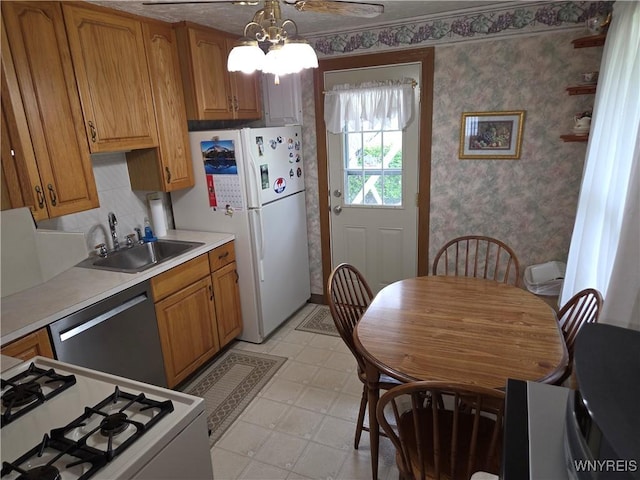 4654 Patricia Dr, Niagara Falls, NY 14305 - kitchen with dishwasher, range, a sink, light floors, and wallpapered walls