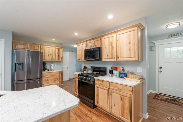 8484 Laura Ln, Richmond, NY 14471 - kitchen with stainless steel refrigerator with ice dispenser, gas range, black microwave, light wood-type flooring, and light brown cabinets