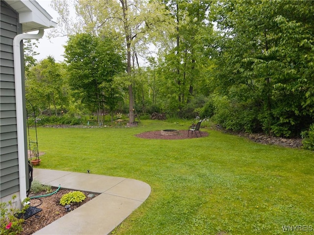 8484 Laura Ln, Richmond, NY 14471 - view of grassy yard with a fire pit
