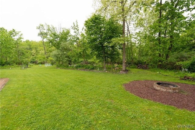8484 Laura Ln, Richmond, NY 14471 - view of grassy yard featuring a fire pit