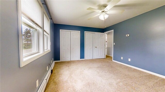 3638 Gorton Rd, Corning, NY 14830 - unfurnished bedroom featuring two closets, carpet flooring, baseboards, and ceiling fan