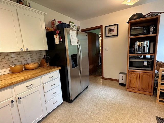 32 Bon Air Ave, Bradford-City, PA 16701 - kitchen featuring wooden counters, appliances with stainless steel finishes, backsplash, and white cabinetry
