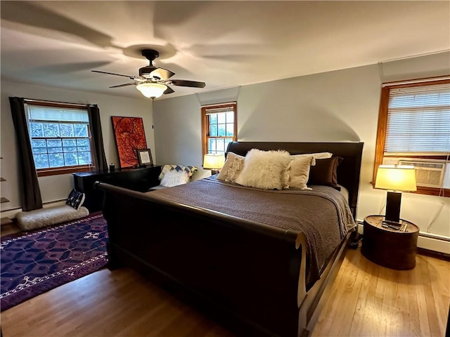 32 Bon Air Ave, Bradford-City, PA 16701 - bedroom with wood finished floors, multiple windows, cooling unit, and a ceiling fan