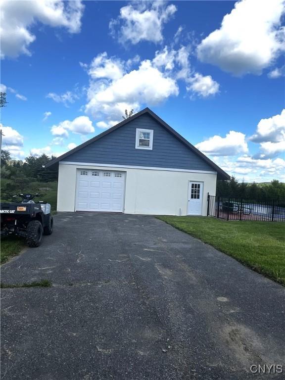 7290 State Route 80, Fabius, NY 13063 - view of home's exterior featuring asphalt driveway and stucco siding