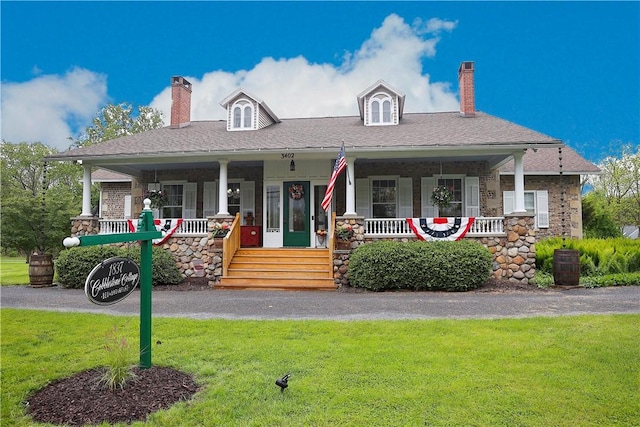 3402 W Lake Rd, Canandaigua Town, NY 14424 - view of front facade with a chimney, a front lawn, covered porch, and stone siding