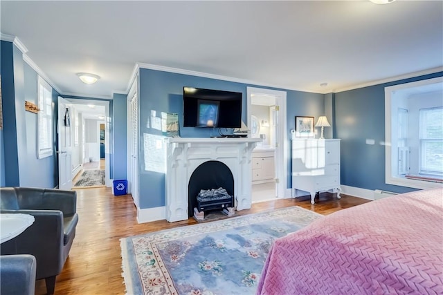 3402 W Lake Rd, Canandaigua Town, NY 14424 - bedroom featuring crown molding, wood finished floors, baseboards, ensuite bathroom, and a fireplace