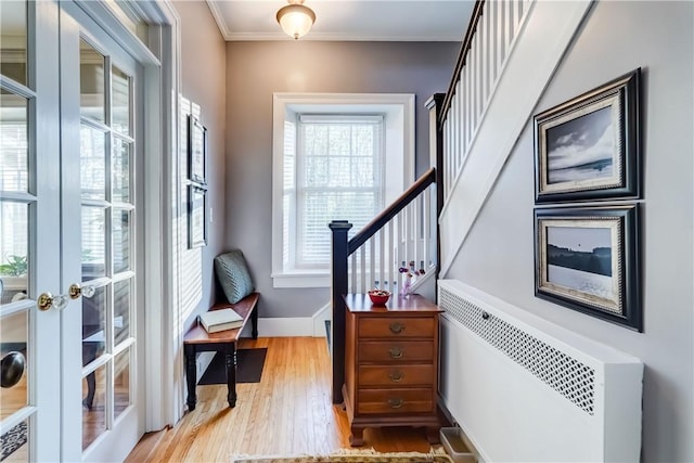 3402 W Lake Rd, Canandaigua Town, NY 14424 - foyer featuring radiator heating unit, french doors, light wood-style floors, baseboards, and stairs
