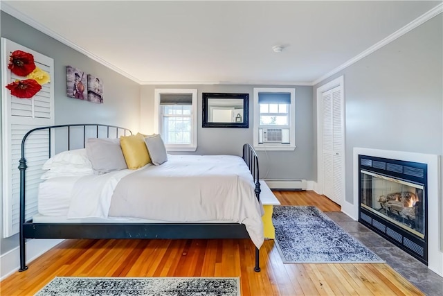 3402 W Lake Rd, Canandaigua Town, NY 14424 - bedroom with a baseboard radiator, wood finished floors, multiple windows, and crown molding