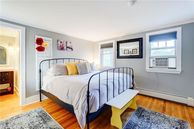 3402 W Lake Rd, Canandaigua Town, NY 14424 - bedroom featuring a baseboard heating unit, crown molding, wood finished floors, and ensuite bath