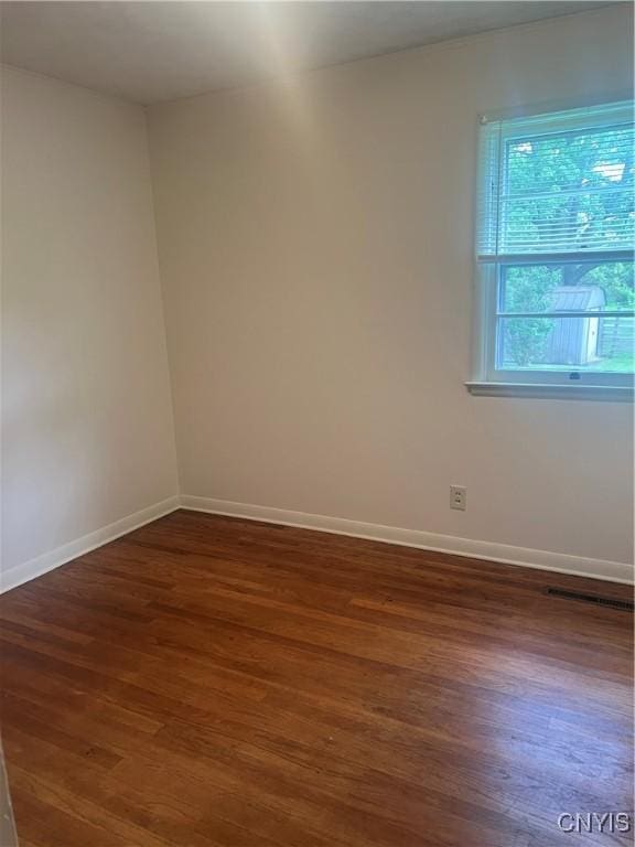 623 E Hamilton Ave N, Sherrill, NY 13461 - unfurnished room with wood finished floors and baseboards