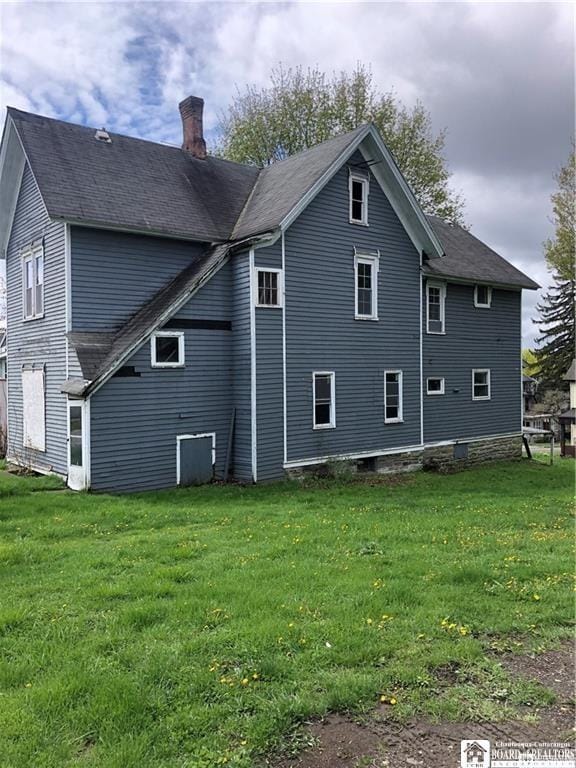 915 N Main St, Jamestown, NY 14701 - rear view of house with a chimney, a yard, and a shingled roof