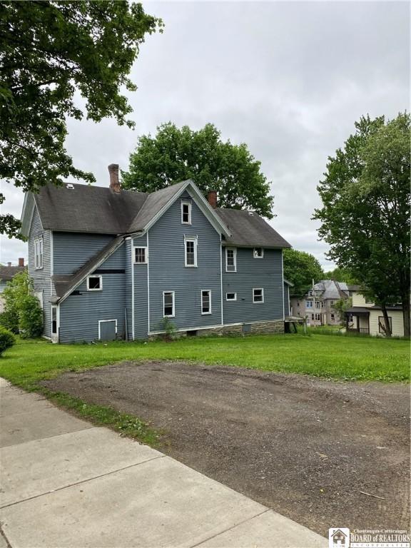 915 N Main St, Jamestown, NY 14701 - view of side of home with a chimney