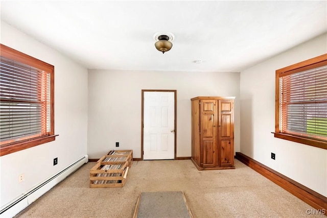 5549 State Route 104th Trl, Scriba, NY 13126 - bedroom featuring a baseboard radiator, multiple windows, light colored carpet, and baseboards