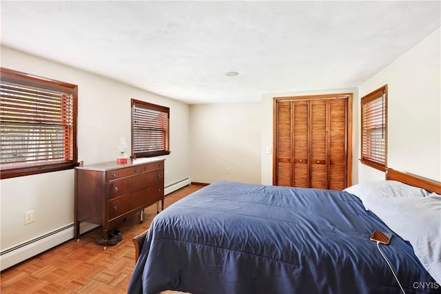 5549 State Route 104th Trl, Scriba, NY 13126 - bedroom featuring a baseboard heating unit and a closet