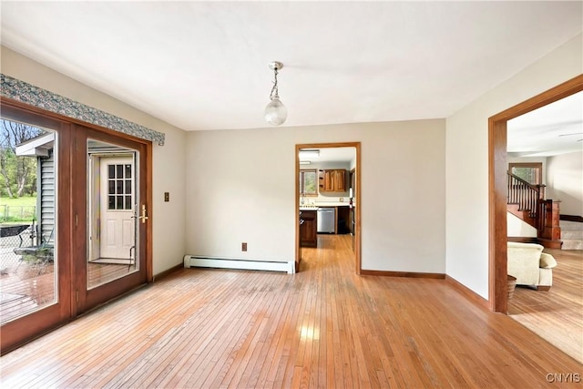5549 State Route 104th Trl, Scriba, NY 13126 - unfurnished dining area with baseboard heating, light wood finished floors, stairway, and baseboards