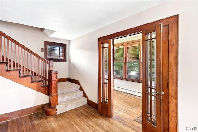 5549 State Route 104th Trl, Scriba, NY 13126 - entryway with baseboard heating, baseboards, french doors, and wood finished floors