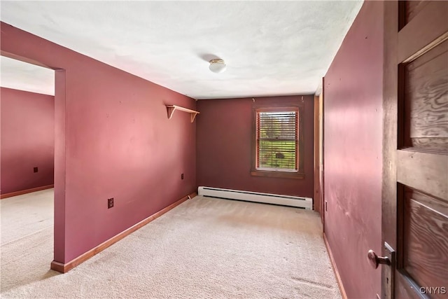 5549 State Route 104th Trl, Scriba, NY 13126 - empty room featuring a baseboard heating unit, carpet flooring, and baseboards
