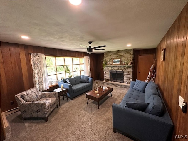 5030 Lincklaen Rd, Cuyler, NY 13158 - carpeted living room with wooden walls, a ceiling fan, a stone fireplace, and a baseboard heating unit