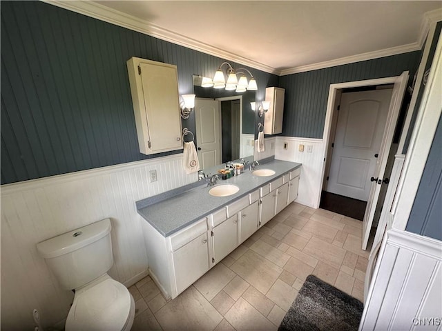 5030 Lincklaen Rd, Cuyler, NY 13158 - full bathroom with wainscoting, double vanity, toilet, crown molding, and a chandelier