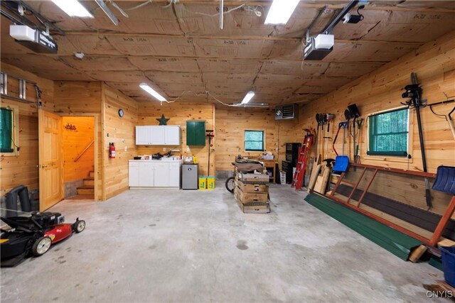 12103 Kincaid Rd, Forestport, NY 13338 - garage featuring a garage door opener and wooden walls