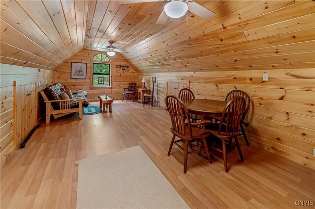 12103 Kincaid Rd, Forestport, NY 13338 - dining area with light wood finished floors, wood walls, ceiling fan, wood ceiling, and vaulted ceiling