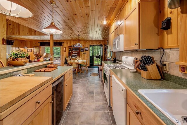 12103 Kincaid Rd, Forestport, NY 13338 - kitchen with white appliances, wood walls, wine cooler, a sink, and pendant lighting